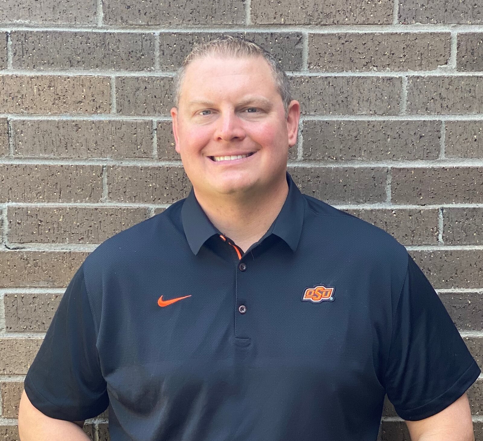 Dr. Dan wearing an Oklahoma State University polo